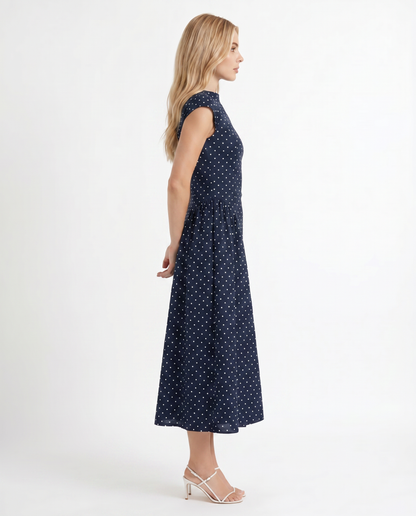 Women navy polka dot midi dress with cap sleeves and fit and flare midi, side profile