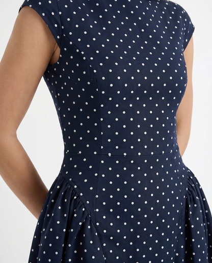 Women polka dot midi dress closeup of crew neckline, cap sleeve, and polka dot print