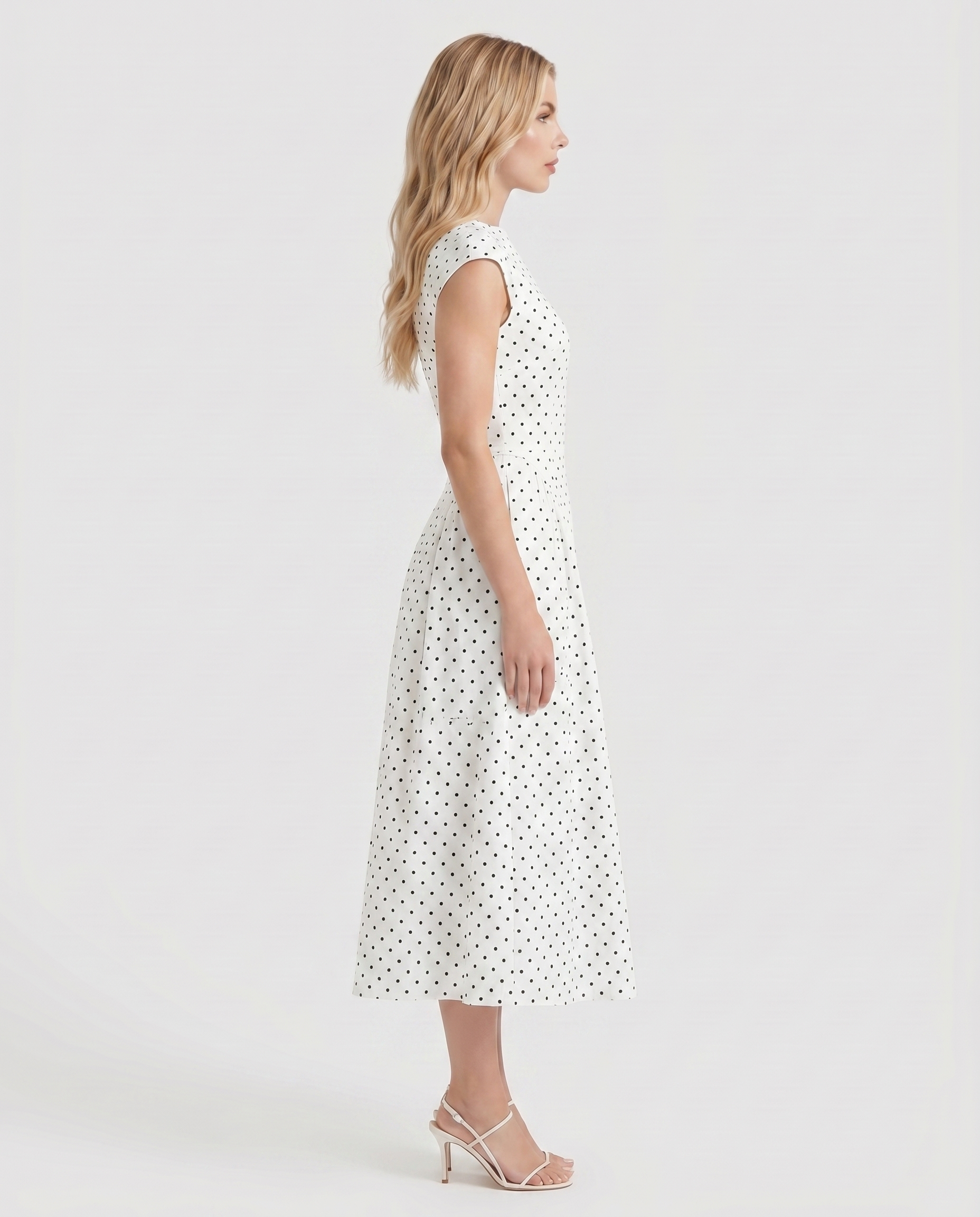 Women white polka dot midi dress with cap sleeves and fit and flare midi, side profile