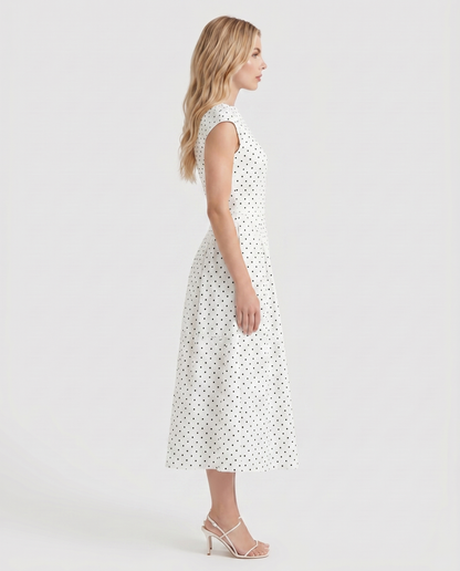 Women white polka dot midi dress with cap sleeves and fit and flare midi, side profile