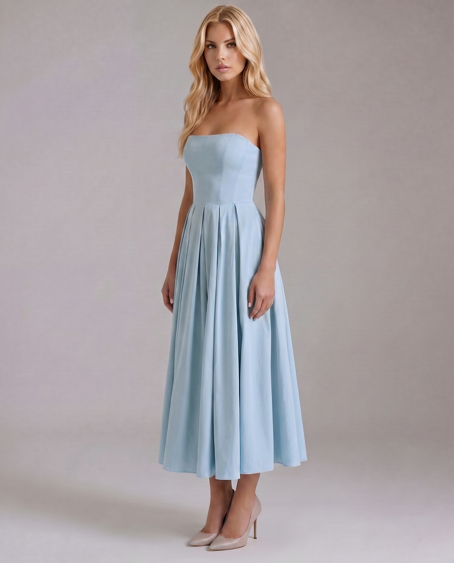 Three-quarter view of the light blue strapless midi dress, highlighting the elegant A-line silhouette