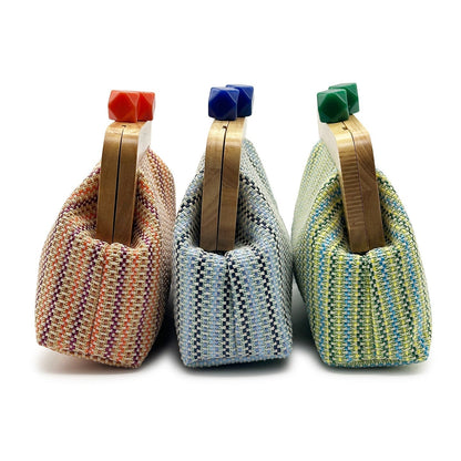 Women orange clutch bag with wooden frame and woven body