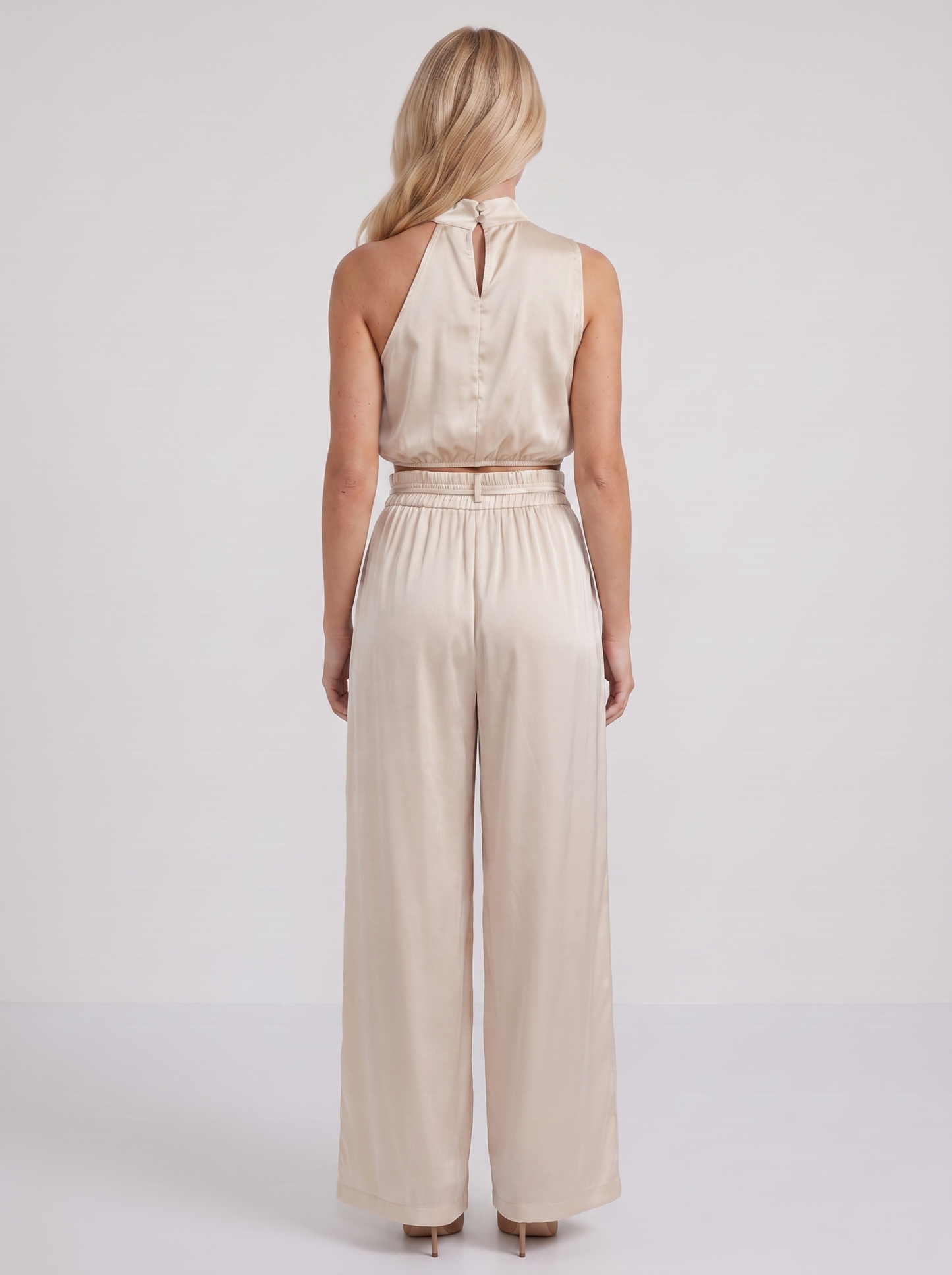 Women champagne pants set with halter crop top and draped satin front