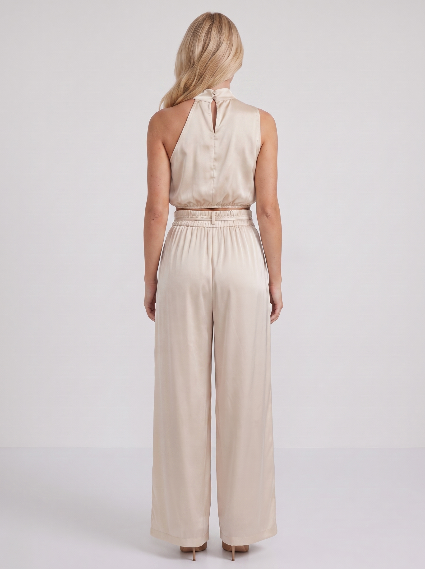 Women champagne pants set with halter crop top and draped satin front