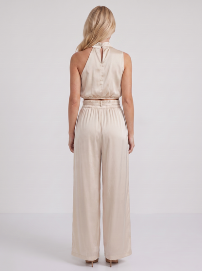 Women champagne pants set with halter crop top and draped satin front