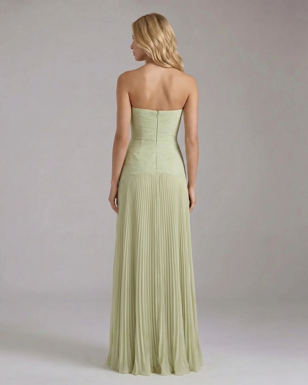 Back view of the Kenzie Forest maxi dress in light green, showing the strapless design and full pleated skirt.