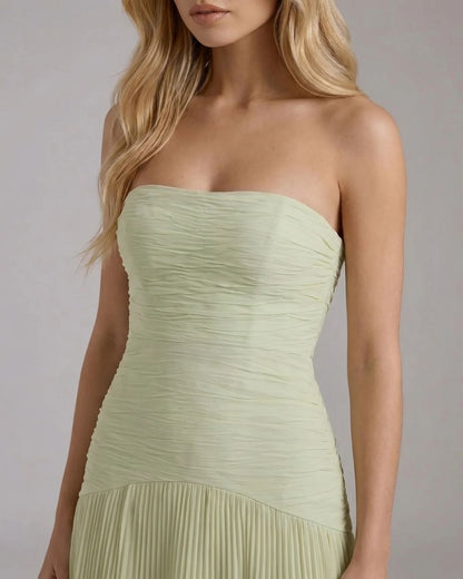 Close-up of the Kenzie Forest maxi dress bodice, showing the light green ruched fabric and the top of the pleated skirt.
