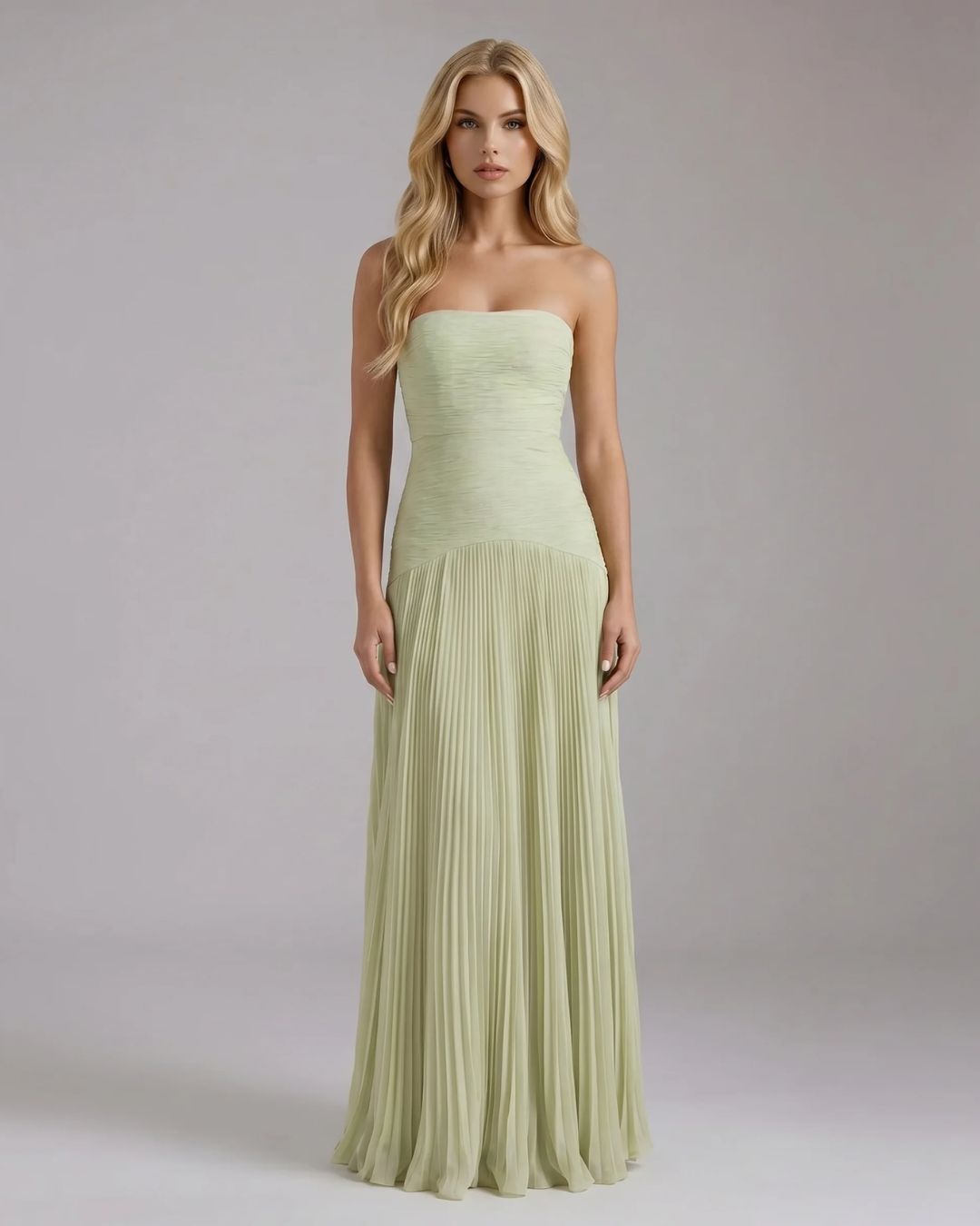 Full-length Kenzie Forest maxi dress in light green, featuring a strapless ruched bodice and a flowing pleated skirt.