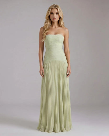 Full-length Kenzie Forest maxi dress in light green, featuring a strapless ruched bodice and a flowing pleated skirt.