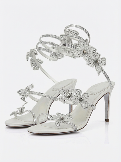Women silver heeled sandals with wrap straps and rhinestone detail