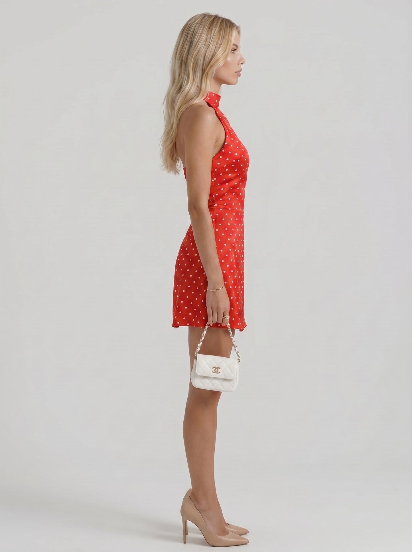 Women red white polka dot high neck halter bodycon mini dress, side profile view