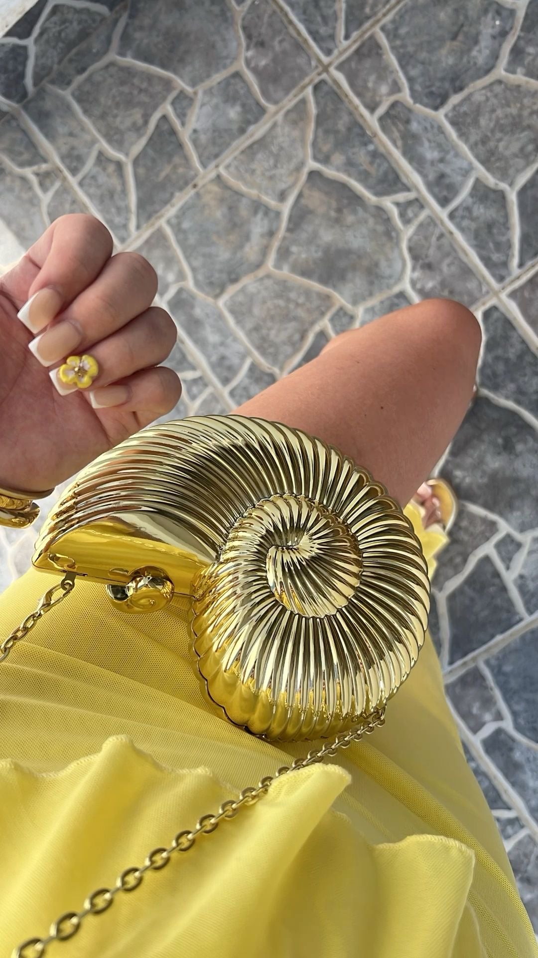 Women gold clutch bag with chain strap and metallic finish