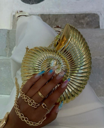 Women gold clutch bag with chain strap and metallic finish