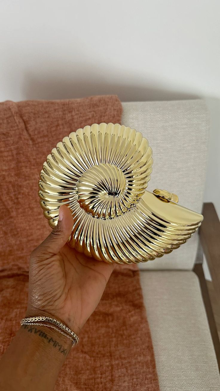 Women gold clutch bag with chain strap and metallic finish