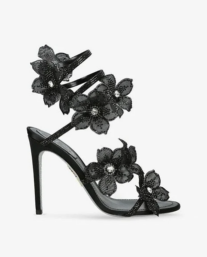 Women black heeled sandals with wrap straps and rhinestone detail