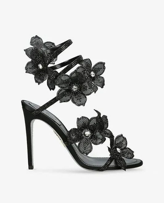 Women black heeled sandals with wrap straps and rhinestone detail