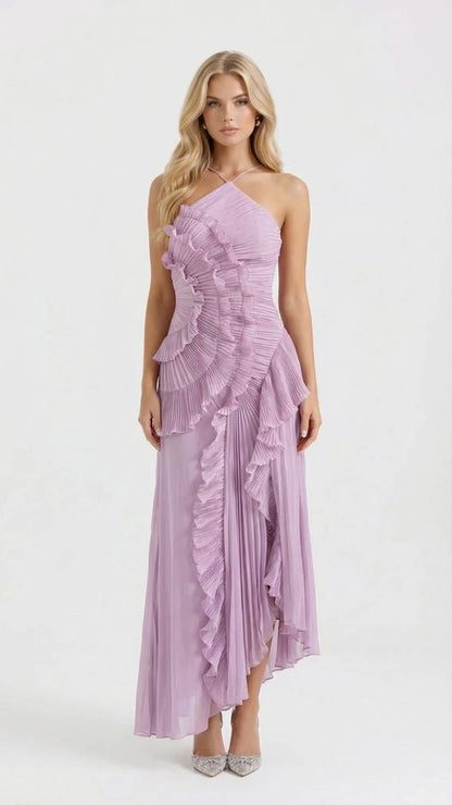 Full-length studio shot of a blonde woman modeling a lavender Nathalie ruffle maxi dress with a halter neckline and asymmetrical pleated ruffles.