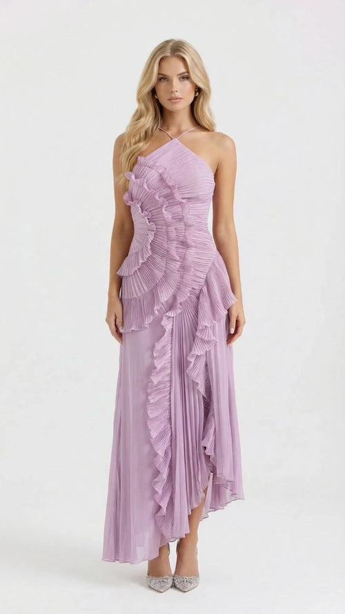 Full-length studio shot of a blonde woman modeling a lavender Nathalie ruffle maxi dress with a halter neckline and asymmetrical pleated ruffles.