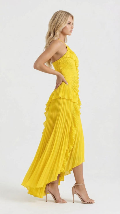 Women's yellow ruffle dress, three-quarter side view showcasing the flowing pleated skirt and asymmetrical hem