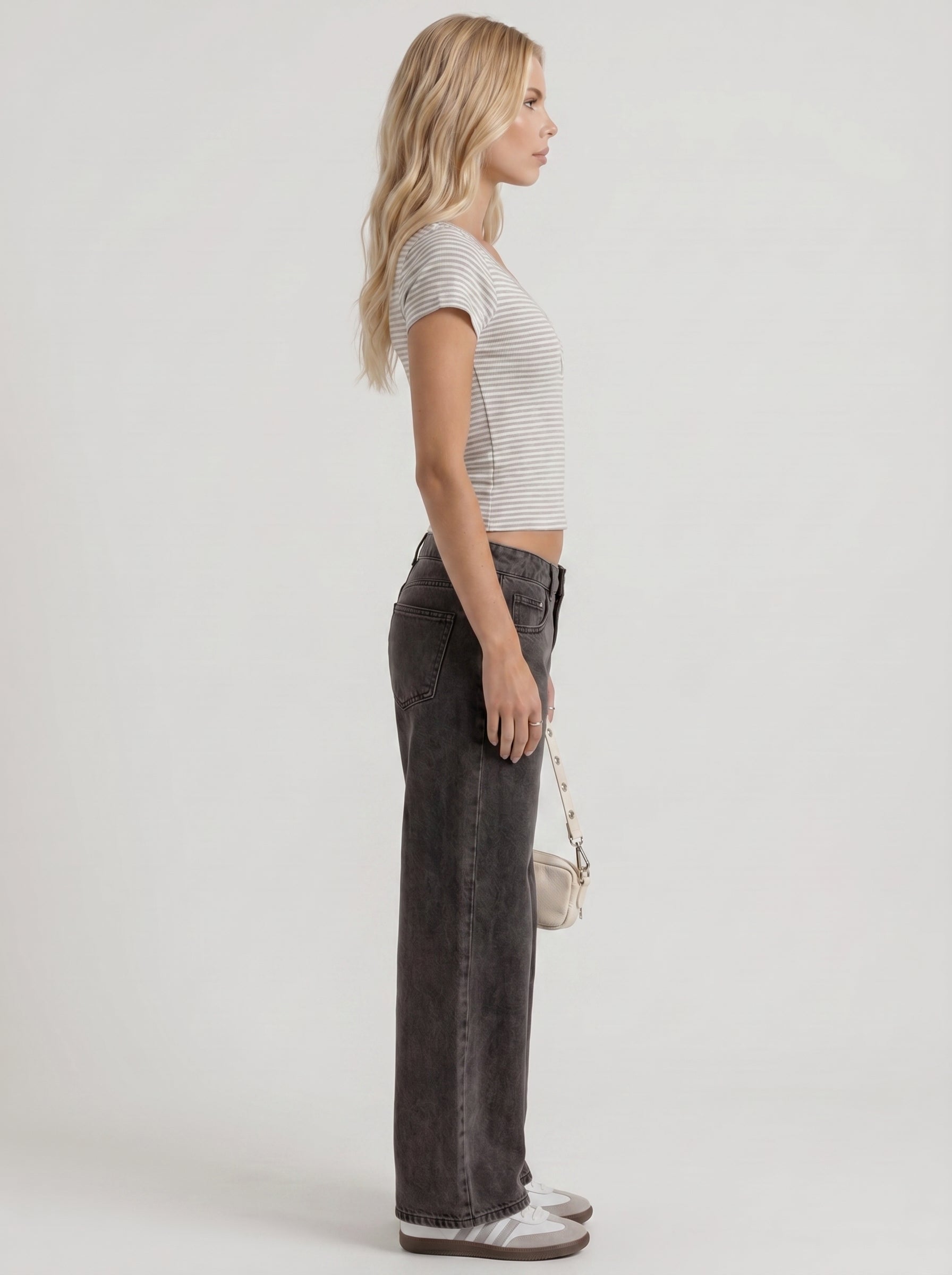 Women black washed low rise wide leg jeans, side profile view