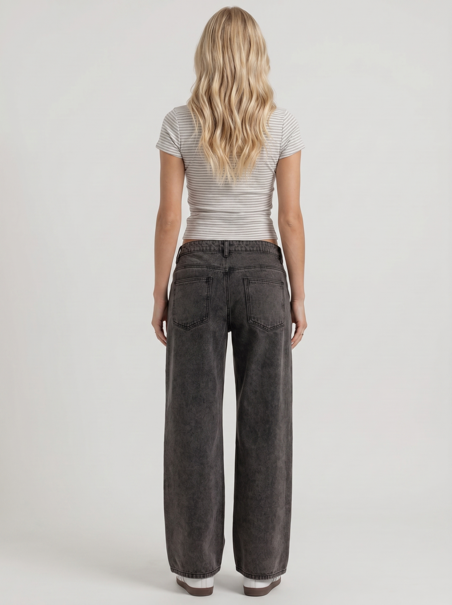 Women black washed low rise wide leg jeans, back view