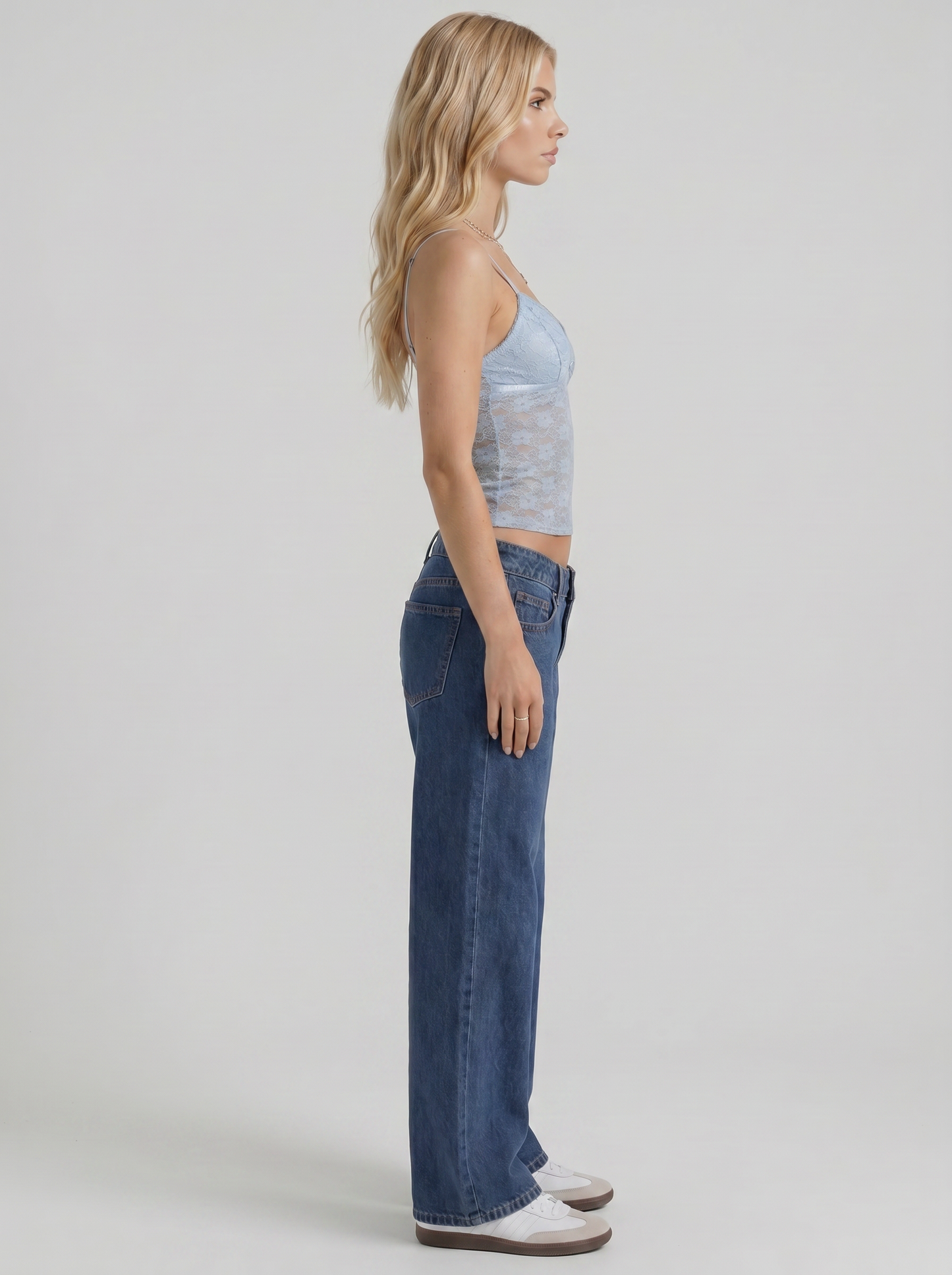 Women blue washed low rise wide leg jeans, side profile view