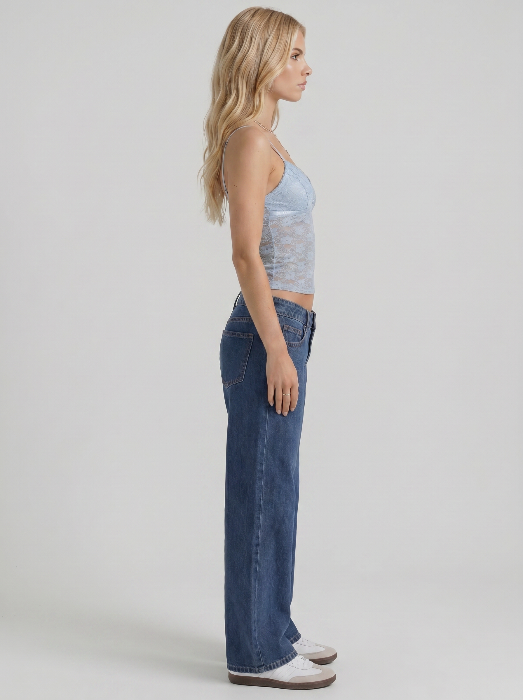 Women blue washed low rise wide leg jeans, side profile view