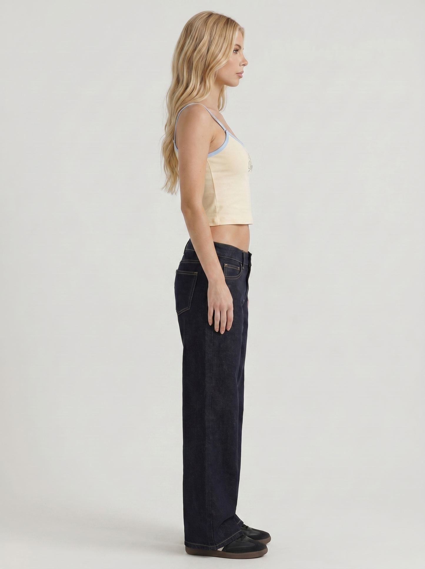 Women indigo blue washed low rise wide leg jeans, side profile view