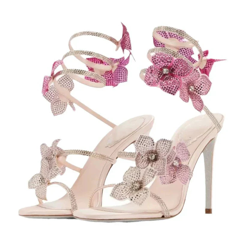 Women baby pink heeled sandals with wrap straps and rhinestone detail