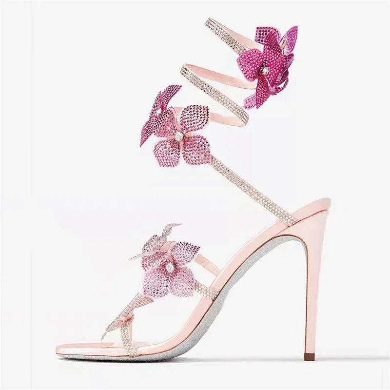 Women baby pink heeled sandals with wrap straps and rhinestone detail
