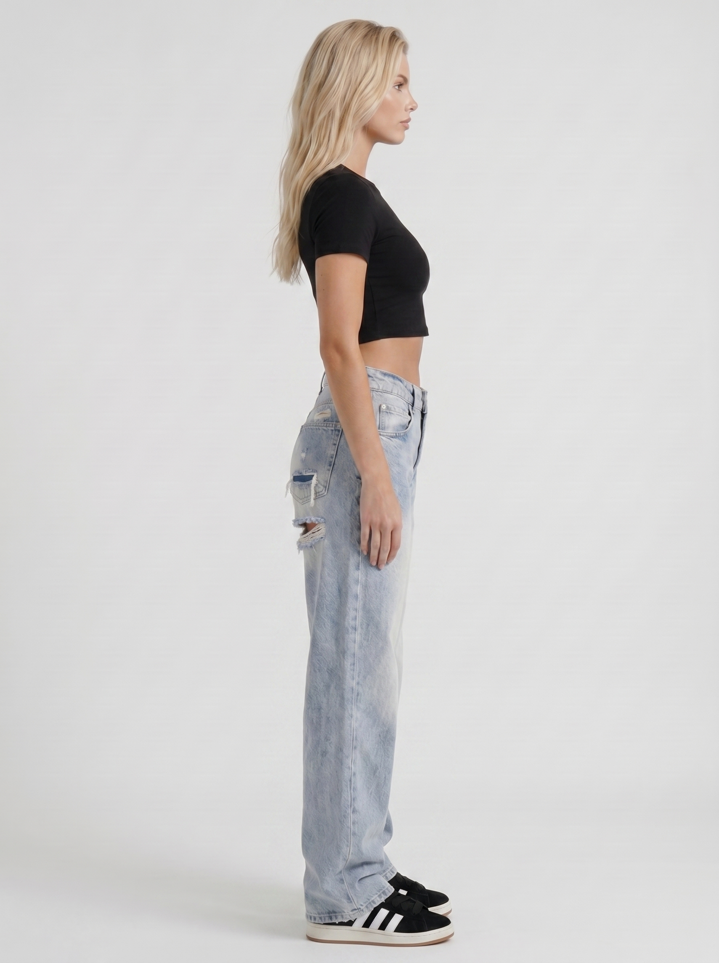Women light blue baggy mid rise distressed wide leg jeans, side profile view
