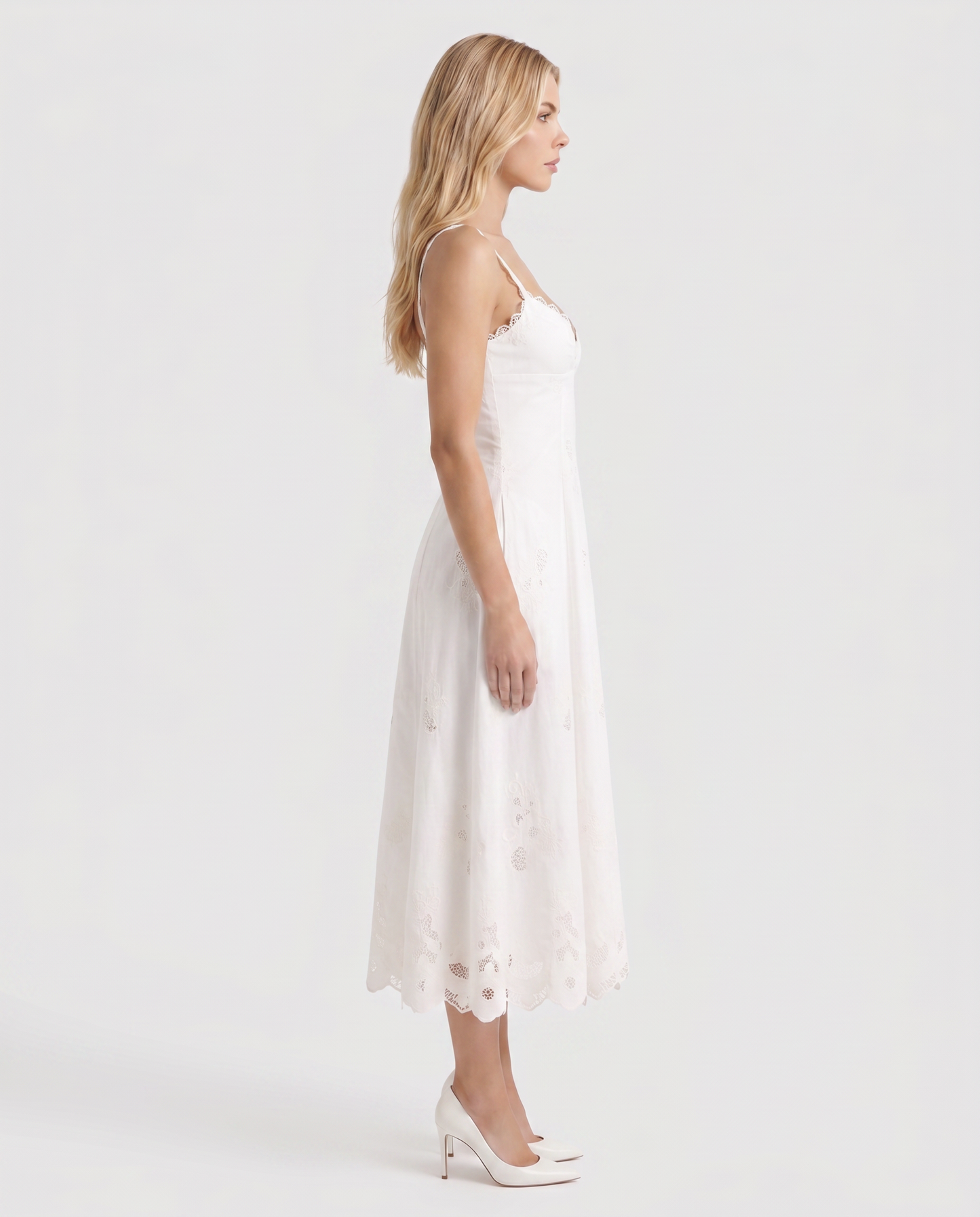 Women white V neck midi dress with embroidered scalloped hem, side profile