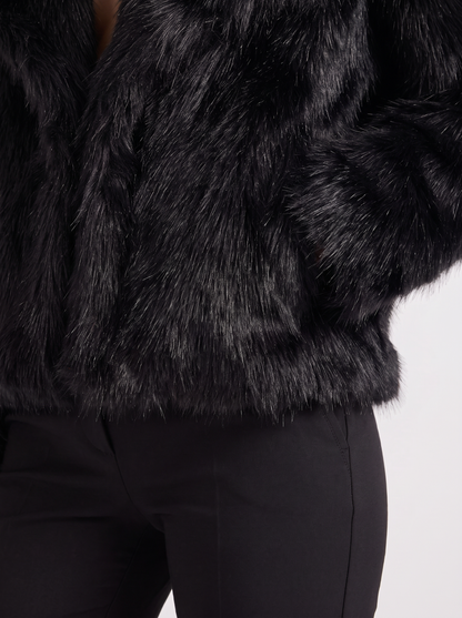 Women's black shaggy jacket with long pile texture and hip length hem