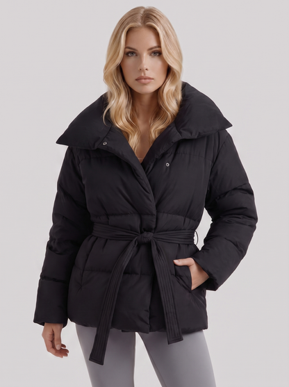Women's black puffer jacket with quilted panels and zip front