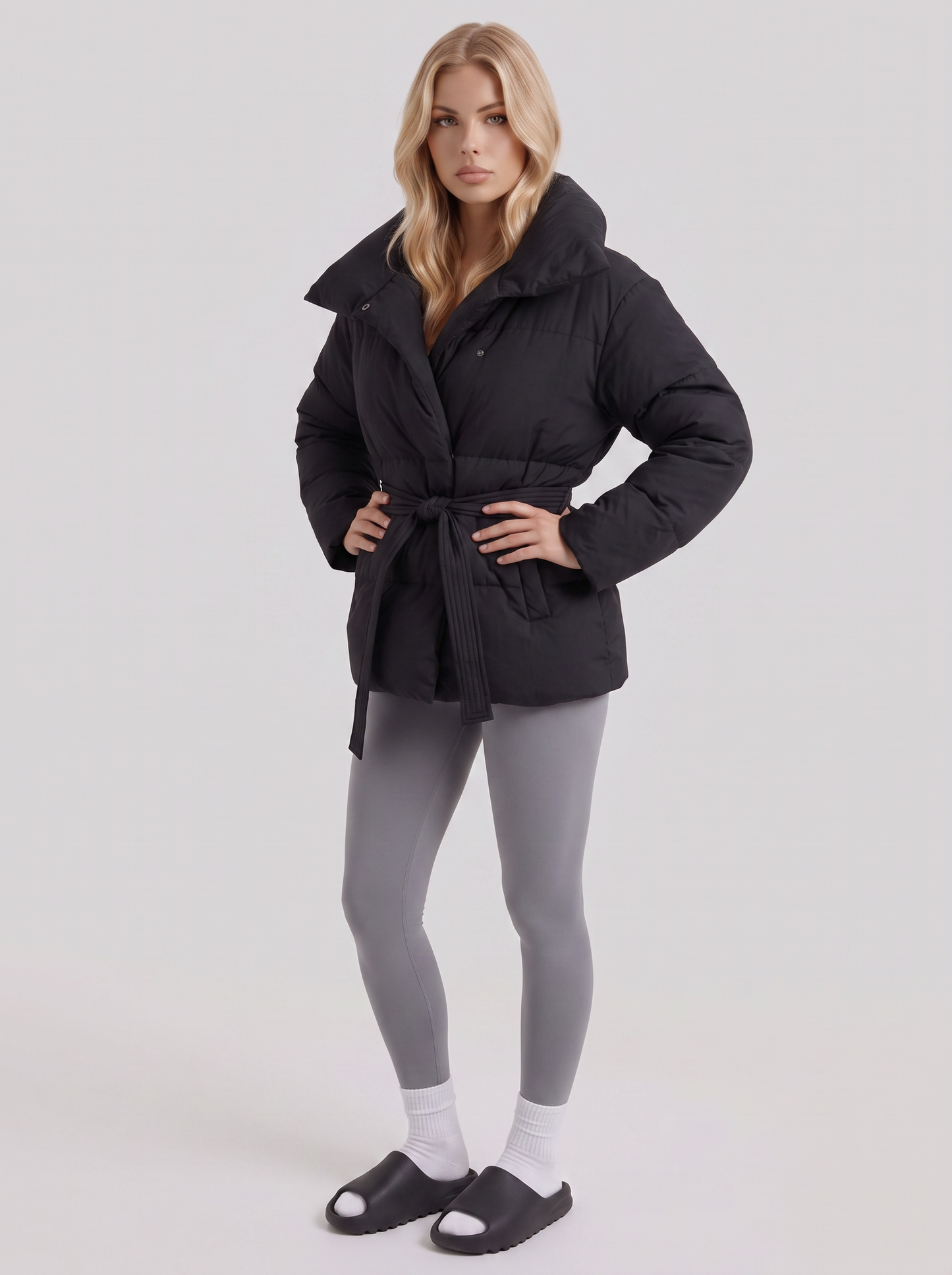 Women's black puffer jacket with quilted panels and zip front