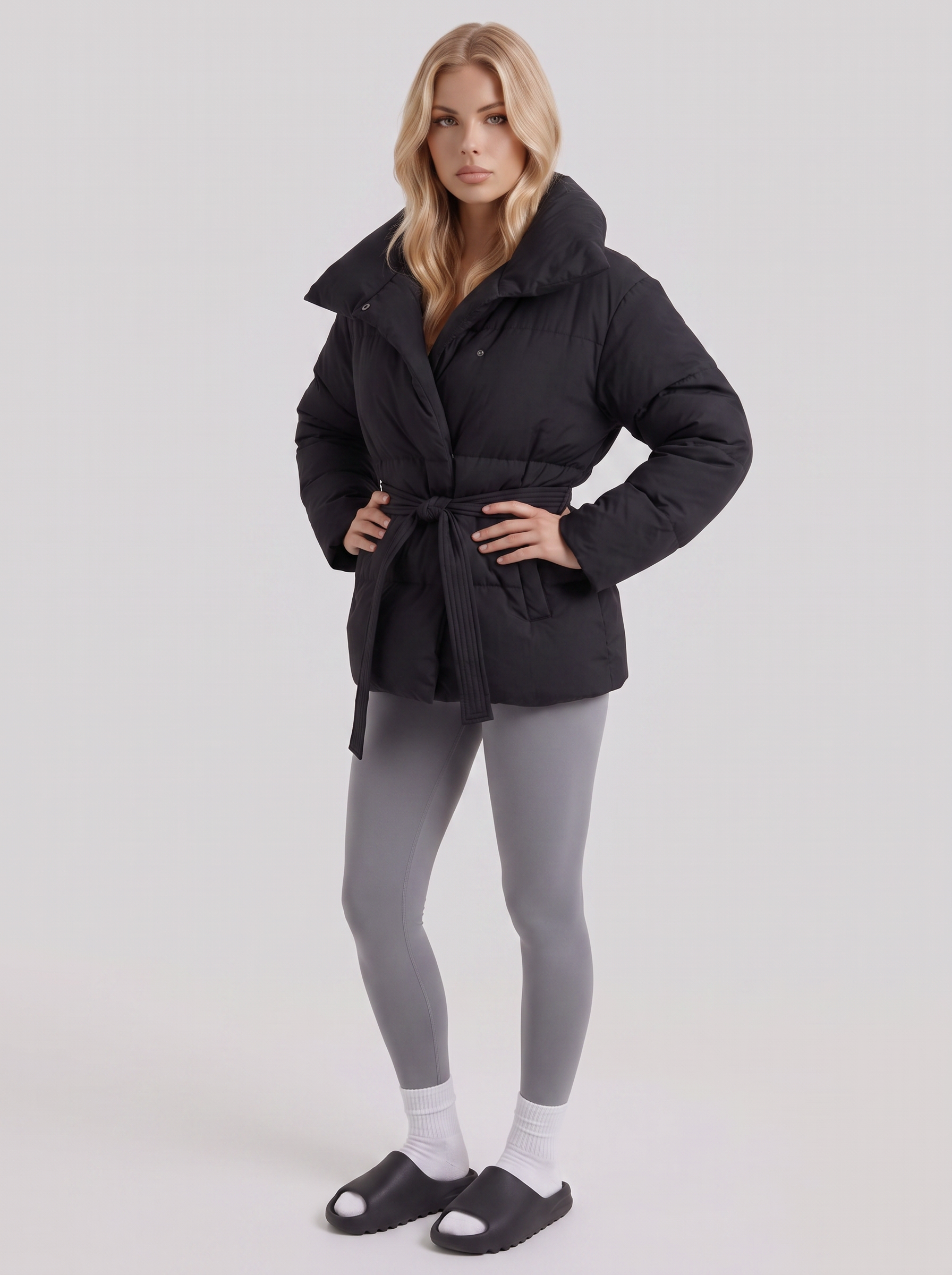 Women's black puffer jacket with quilted panels and zip front