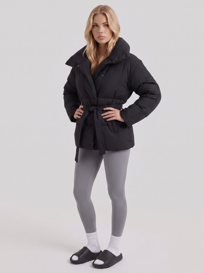 Women's black puffer jacket with quilted panels and zip front