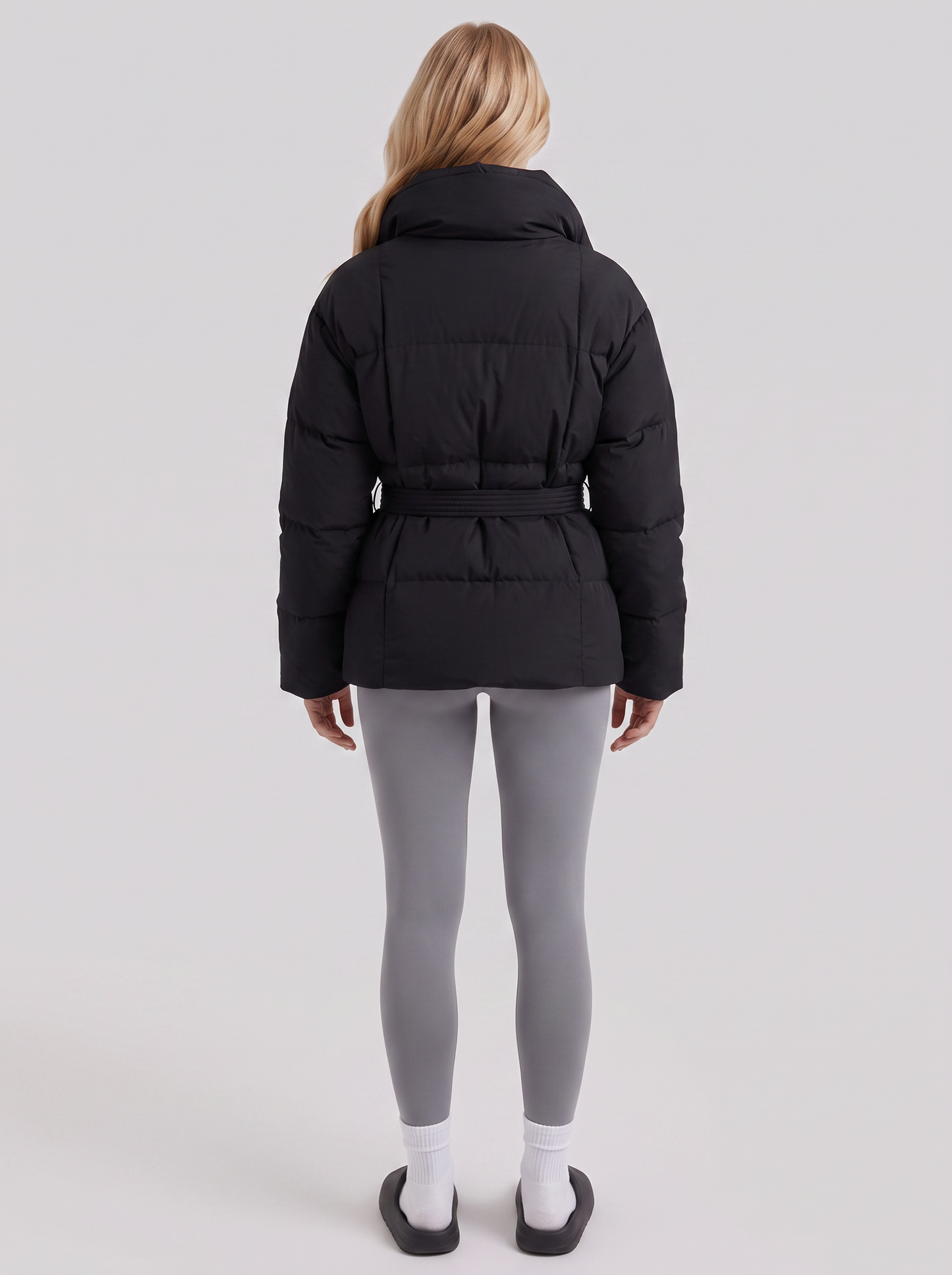 Women's black puffer jacket with quilted panels and zip front