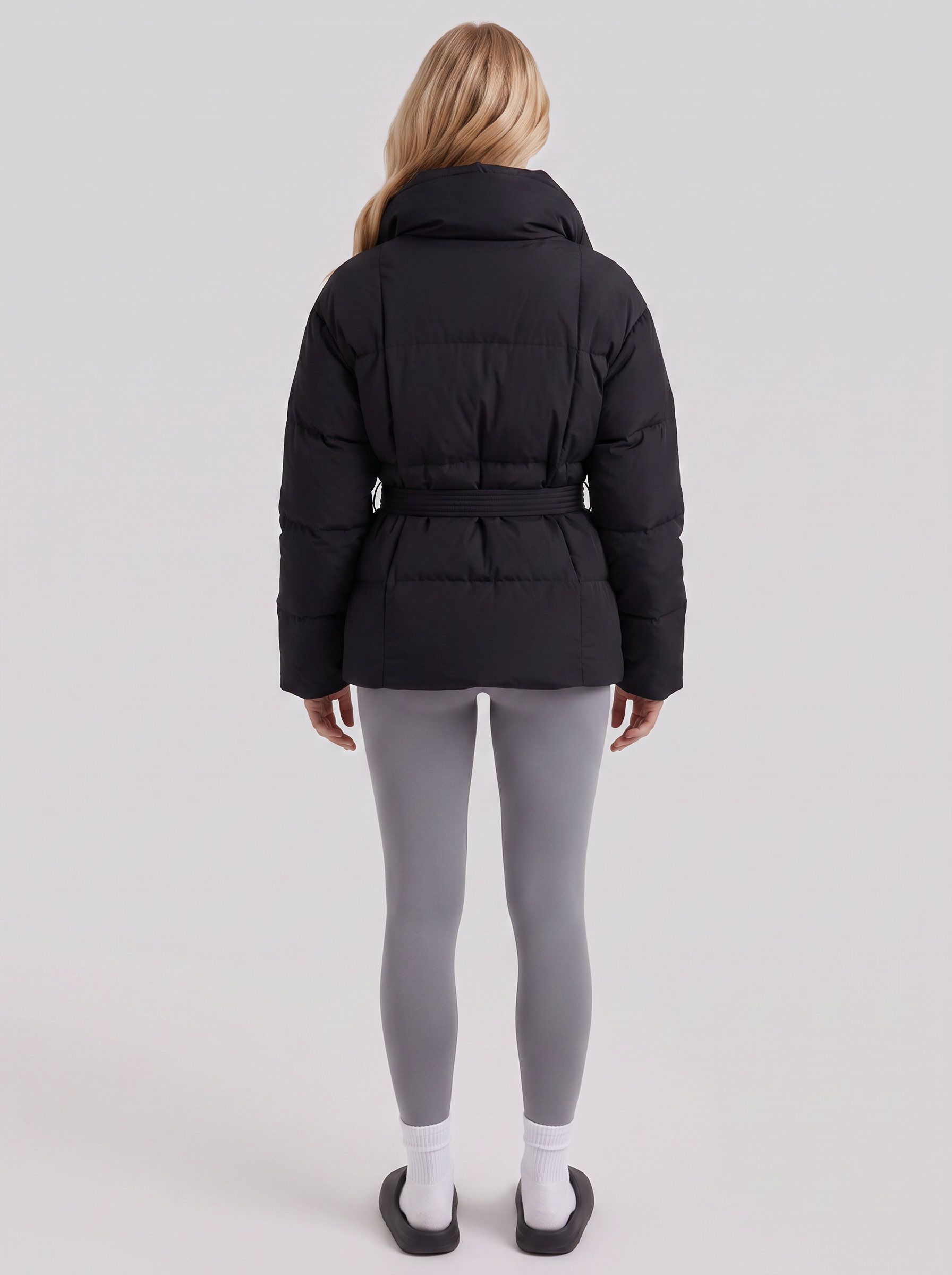Women's black puffer jacket with quilted panels and zip front