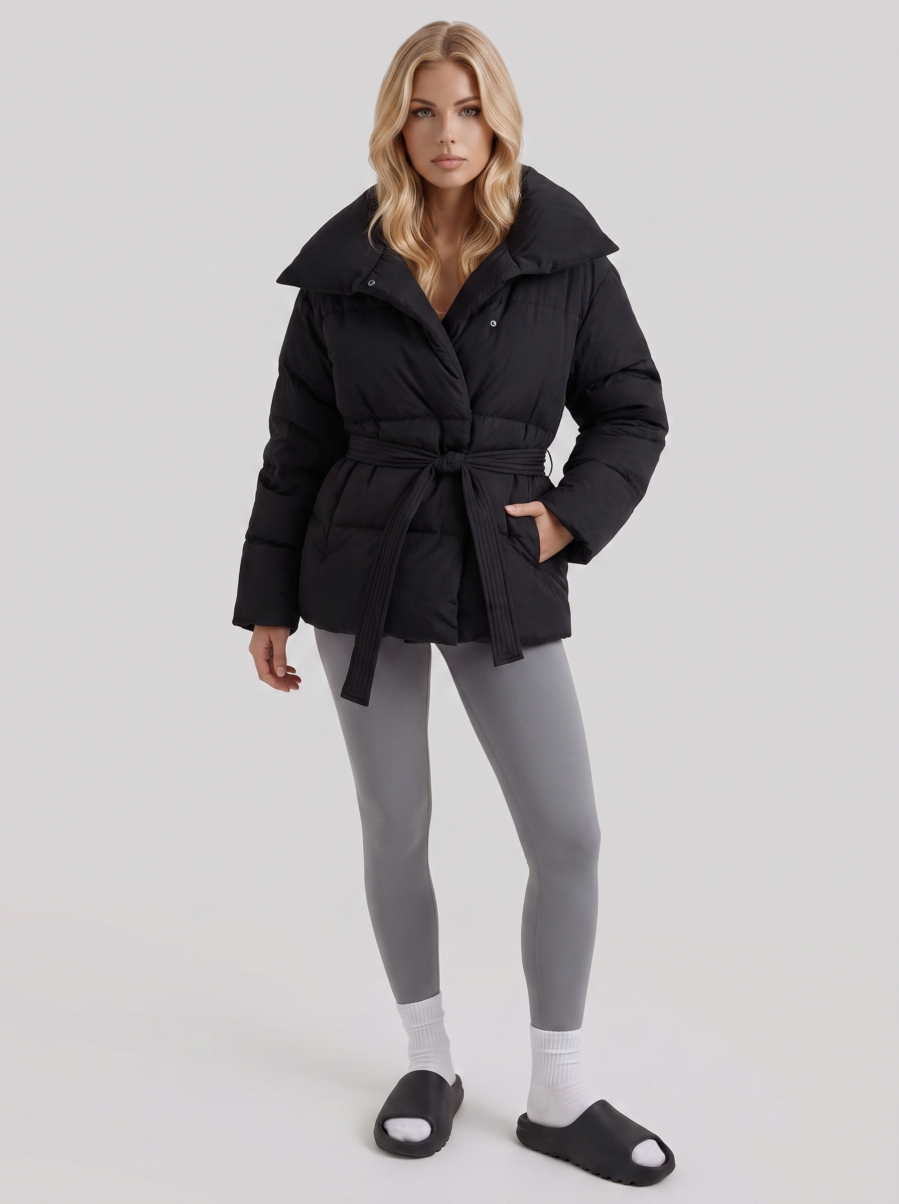 Women's black puffer jacket with quilted panels and zip front