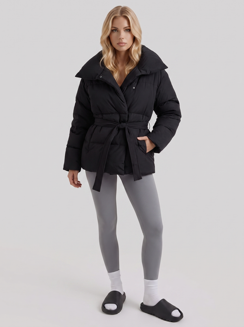 Women's black puffer jacket with quilted panels and zip front