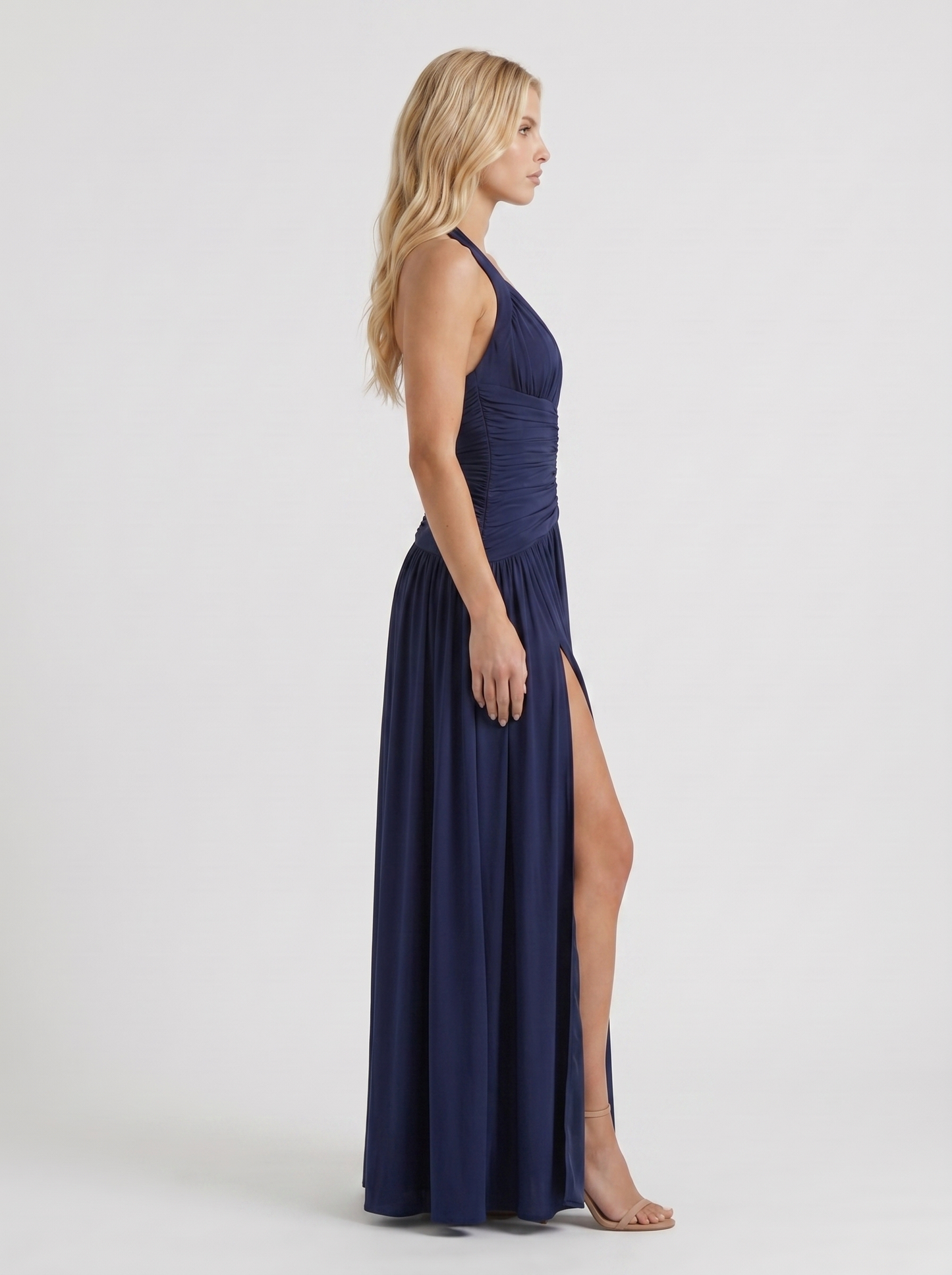 Women navy halter ruched maxi dress with drop waist seam, side profile