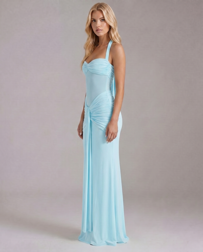 Women's blue ruched maxi dress with halter neckline and draped skirt side view