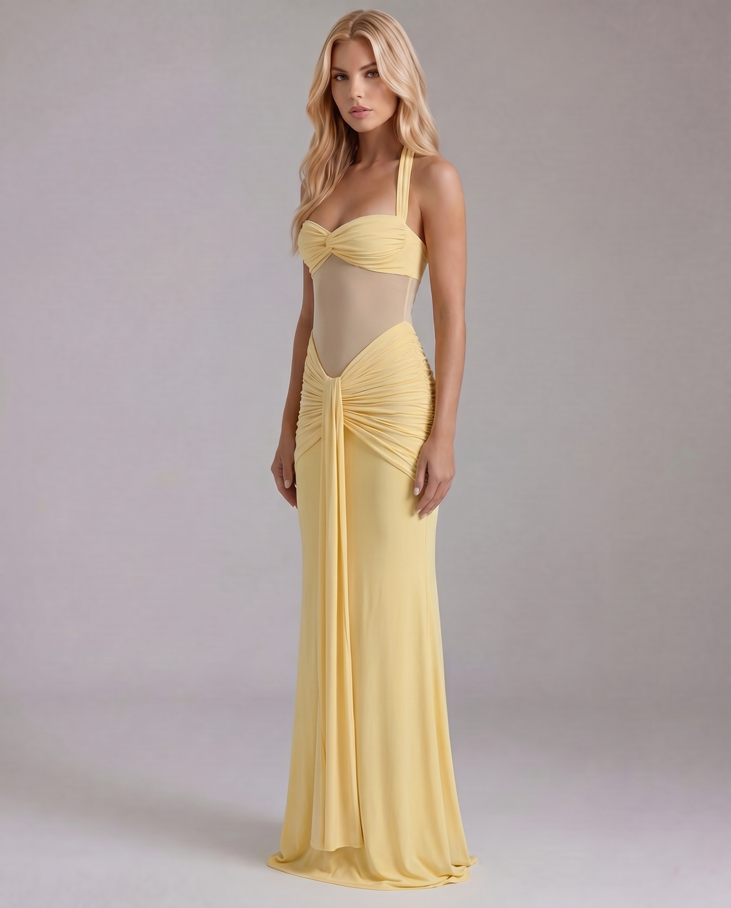 Women's yellow ruched maxi dress with draped waist detail, slightly angled front view.